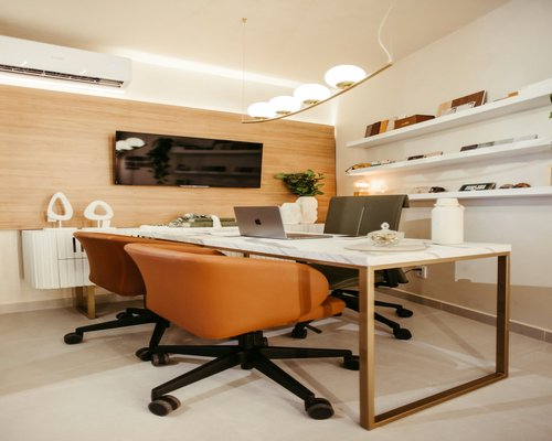 Modern office workspace showing a desk chair and laptop set up for a long working day