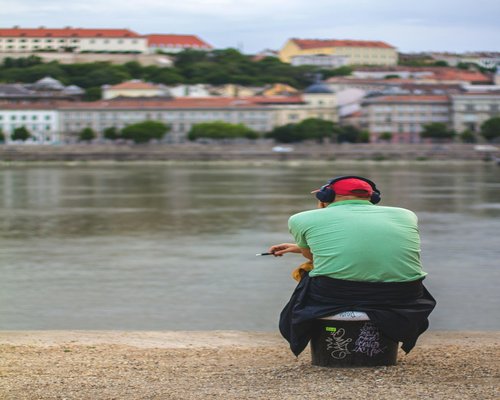 A person taking a calm walk beside the Danube river in Budapest during a relaxing afternoon