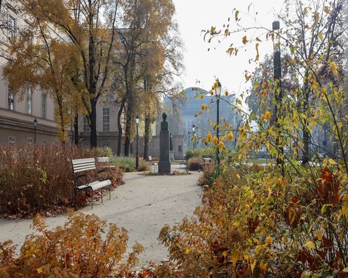 A peaceful view of an empty path in a Hungarian city park during autumn